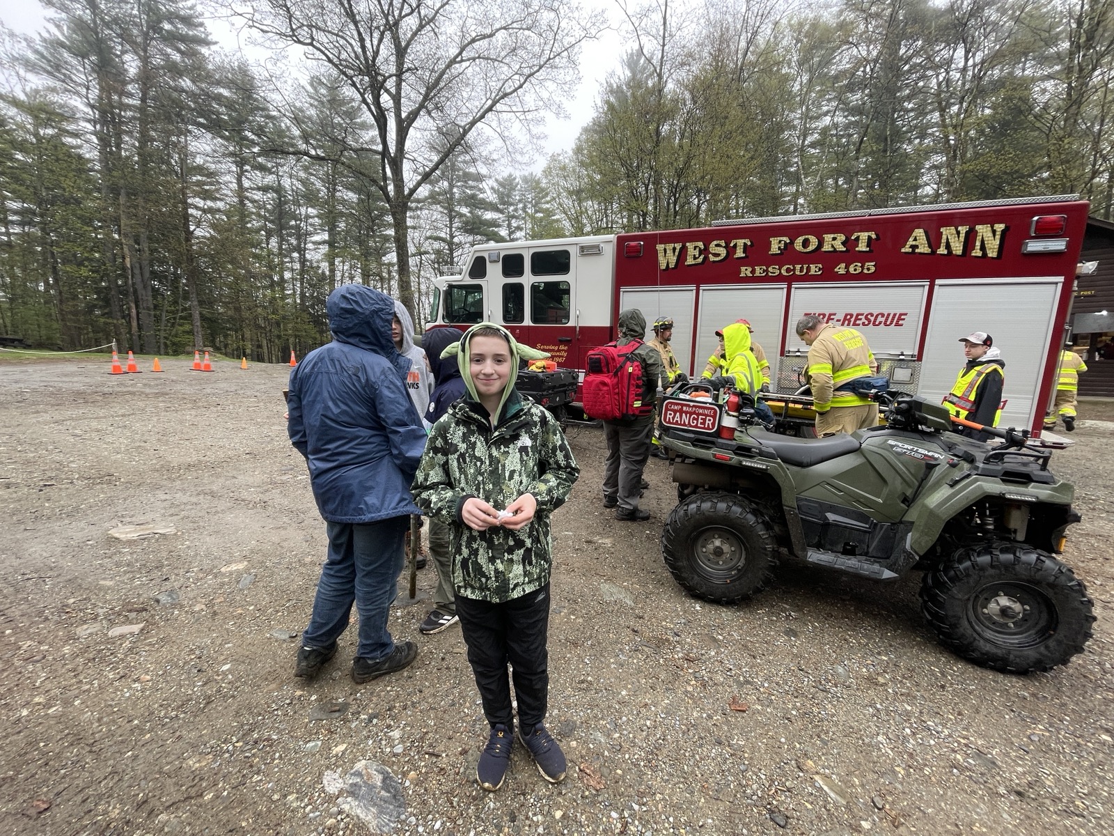 A young Scout posing in front of a fire-rescue vehicle.